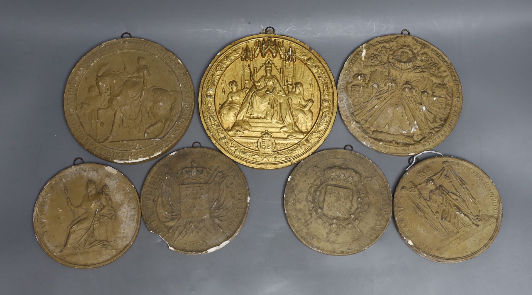 Two Napoleonic commemorative plaster roundels, a Louis VIll, a Louis Philippe, a Queen Elizabeth l and two of Queen Victoria, largest 16,5 cms diameter